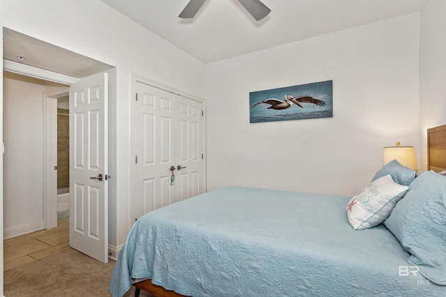 carpeted bedroom featuring a closet and ceiling fan