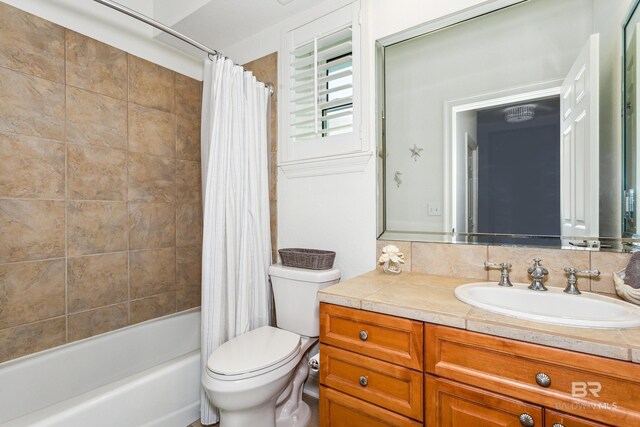 full bathroom with vanity, shower / tub combo, and toilet