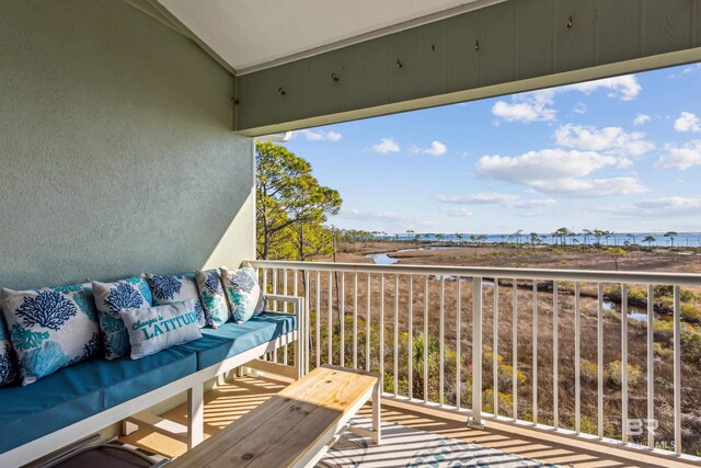 balcony featuring outdoor lounge area and a water view