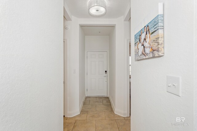 corridor featuring light tile patterned floors