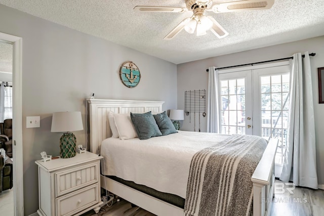 bedroom with access to exterior, french doors, light hardwood / wood-style flooring, and ceiling fan