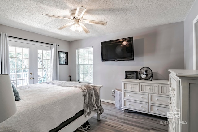 bedroom featuring french doors, wood-type flooring, access to exterior, a textured ceiling, and ceiling fan