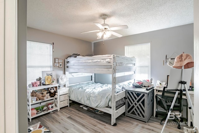 bedroom featuring a textured ceiling, hardwood / wood-style flooring, and ceiling fan