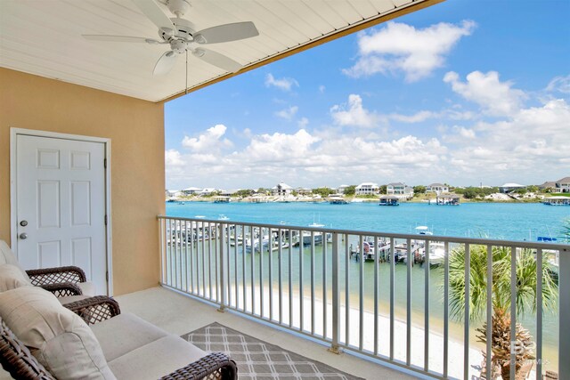 balcony featuring a water view and ceiling fan