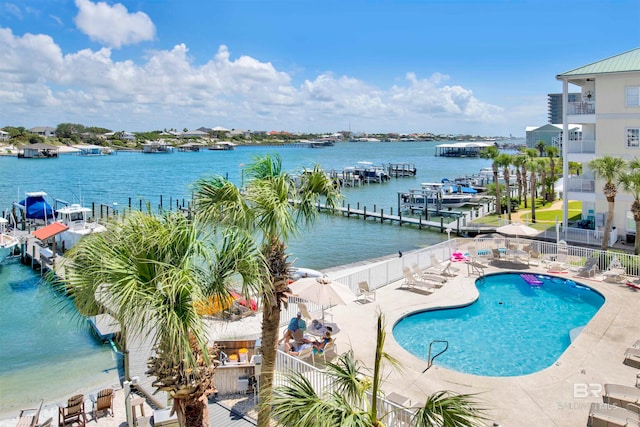 view of swimming pool featuring a water view and a patio