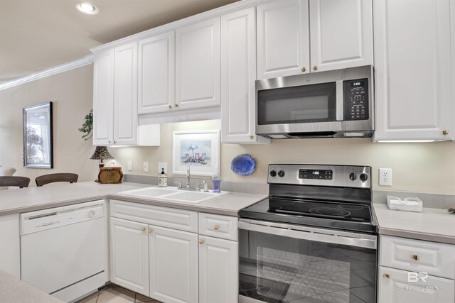 kitchen featuring sink, crown molding, stainless steel appliances, and white cabinets