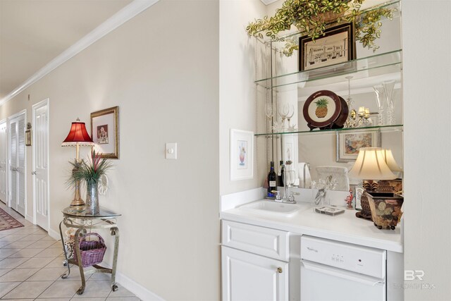 bar with light tile patterned flooring, white cabinets, dishwasher, sink, and ornamental molding