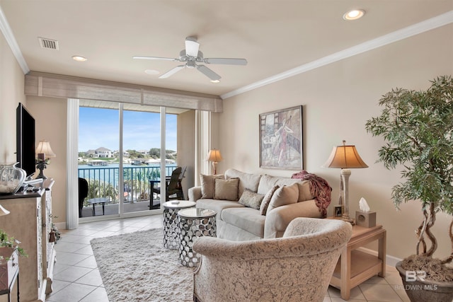 living room with light tile patterned flooring, ceiling fan, a water view, and crown molding