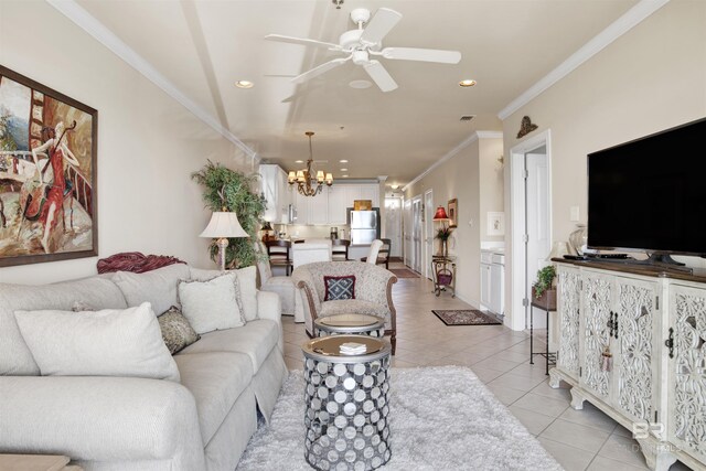 living room featuring crown molding, ceiling fan with notable chandelier, and light tile patterned floors