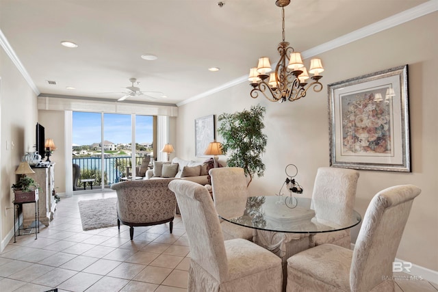 tiled dining area featuring ornamental molding, a water view, and ceiling fan with notable chandelier