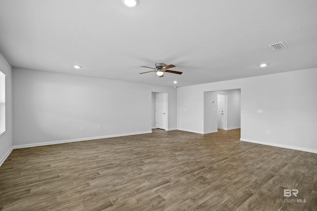 spare room with ceiling fan and dark hardwood / wood-style flooring