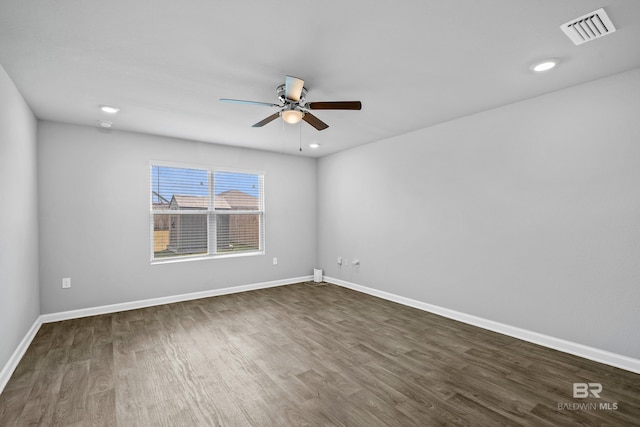 unfurnished room featuring dark wood-type flooring and ceiling fan