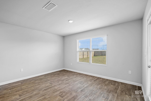 unfurnished room with hardwood / wood-style flooring