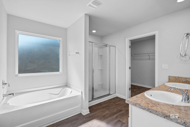 bathroom featuring vanity, independent shower and bath, and wood-type flooring