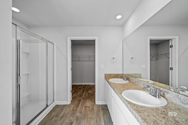 bathroom with vanity, an enclosed shower, and hardwood / wood-style floors