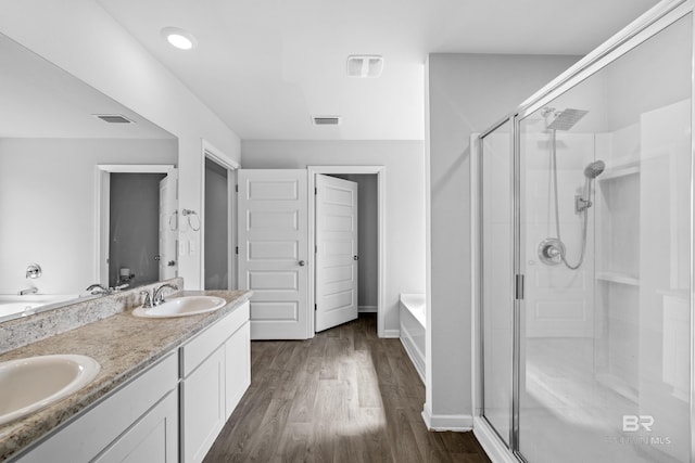 bathroom with vanity, wood-type flooring, and independent shower and bath