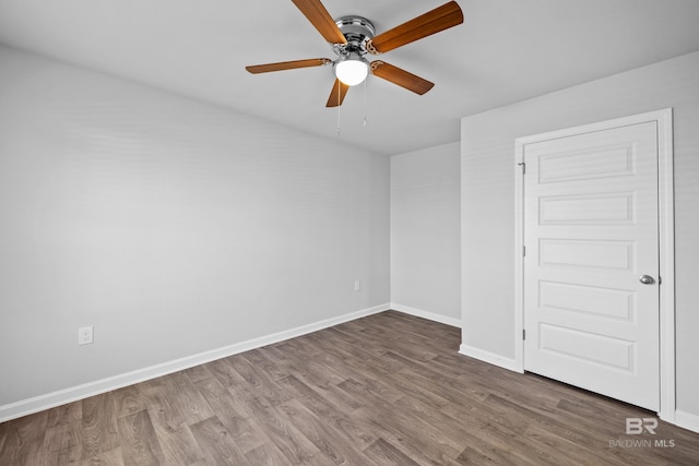 empty room with hardwood / wood-style floors and ceiling fan