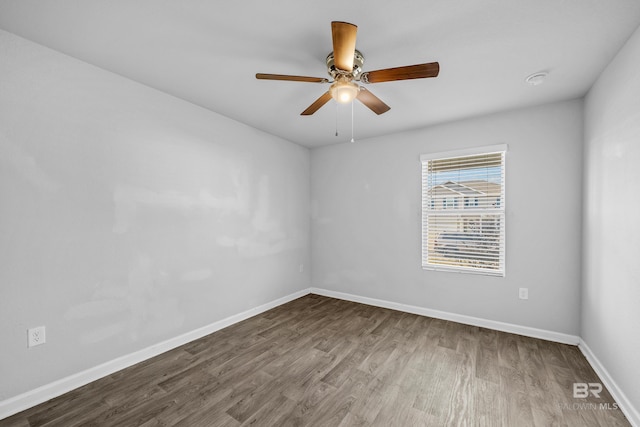 unfurnished room with ceiling fan and wood-type flooring