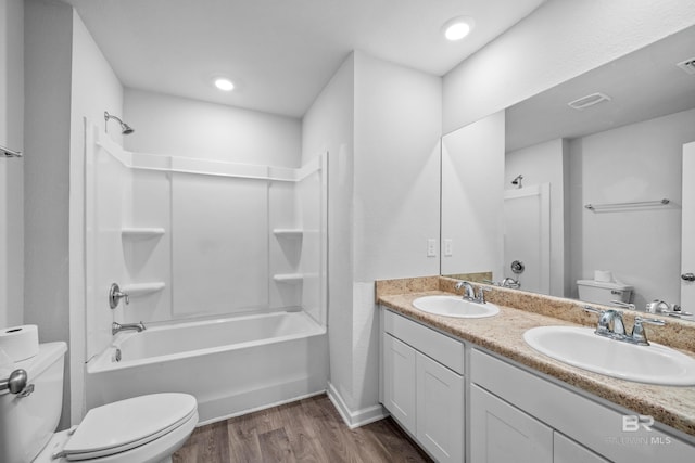 full bathroom with vanity, tub / shower combination, hardwood / wood-style floors, and toilet