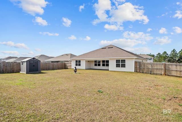 back of house with a lawn and a storage unit