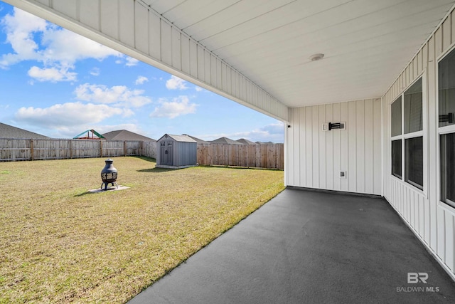 view of yard with a shed and a patio