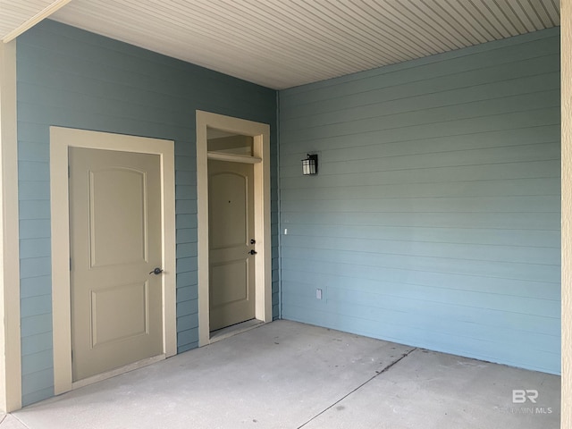 doorway to property featuring a carport