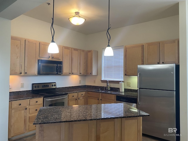 kitchen featuring appliances with stainless steel finishes, hanging light fixtures, sink, and light brown cabinets