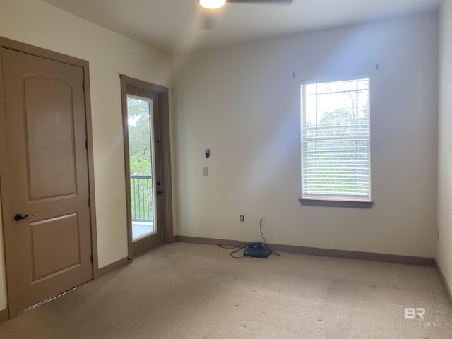 spare room featuring light carpet and ceiling fan