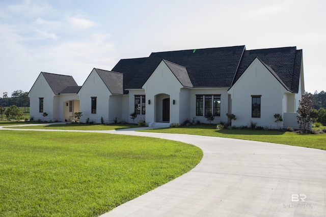 21767 Gallery Blvd, Fairhope, AL 36532 - french country style house featuring a front lawn, curved driveway, and a shingled roof