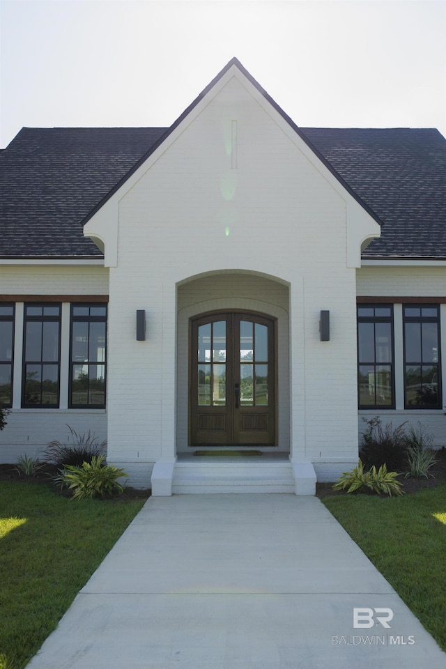 21767 Gallery Blvd, Fairhope, AL 36532 - property entrance featuring roof with shingles, brick siding, french doors, and a lawn