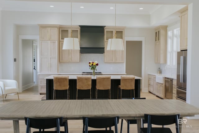 21767 Gallery Blvd, Fairhope, AL 36532 - kitchen with exhaust hood, a sink, light countertops, an island with sink, and recessed lighting
