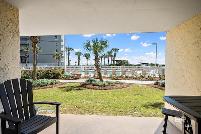 view of yard featuring a community pool and fence