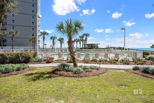 pool with a lawn and fence