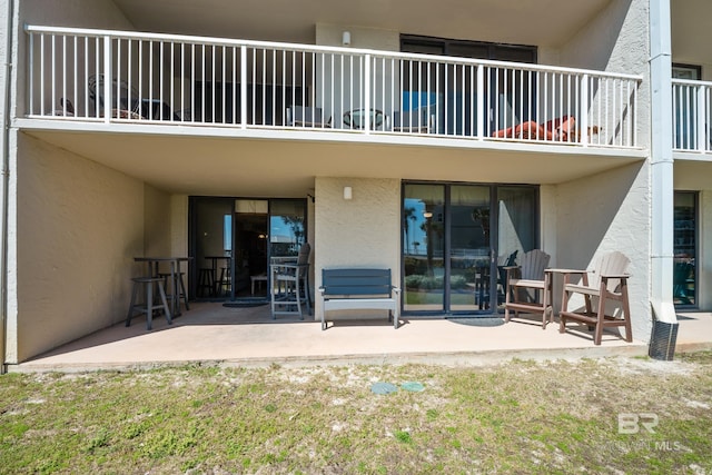 exterior space featuring stucco siding and a patio area