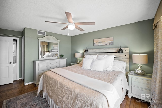 bedroom with visible vents, a textured ceiling, wood finished floors, and a ceiling fan