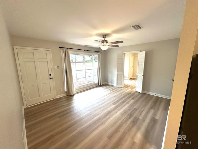 unfurnished room featuring hardwood / wood-style floors and ceiling fan