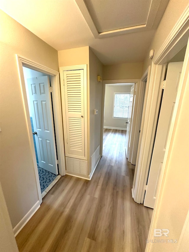 hall with wood-type flooring