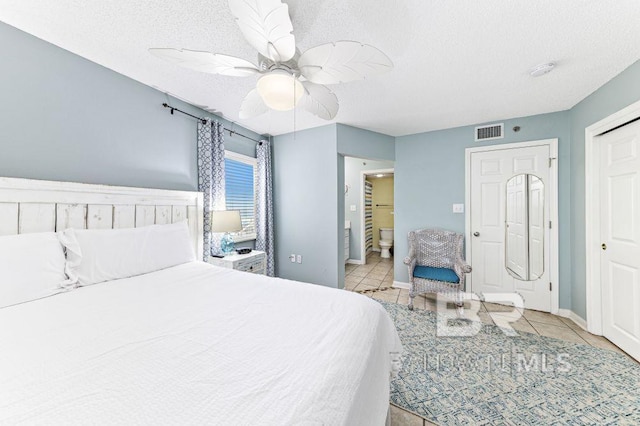 tiled bedroom featuring a textured ceiling, a closet, and ceiling fan