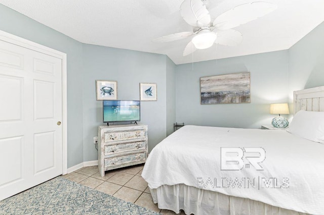 tiled bedroom with ceiling fan