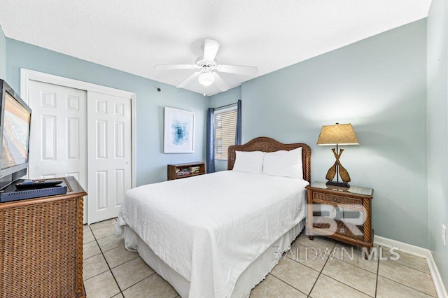 bedroom with ceiling fan, a closet, and light tile patterned floors