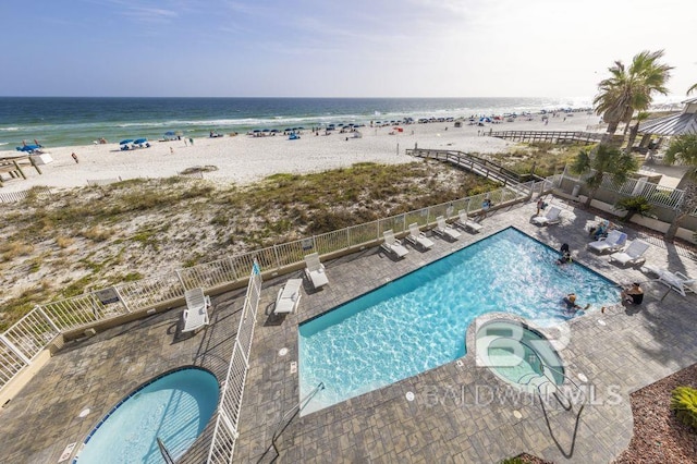 drone / aerial view with a beach view and a water view