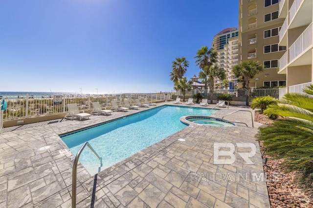 view of swimming pool with a community hot tub and a patio area