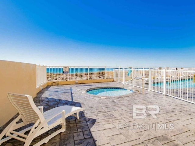 view of swimming pool with a patio area, a community hot tub, and a water view