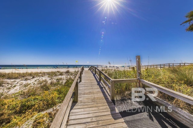 surrounding community featuring a water view and a view of the beach