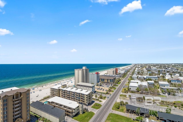 birds eye view of property with a water view and a view of the beach