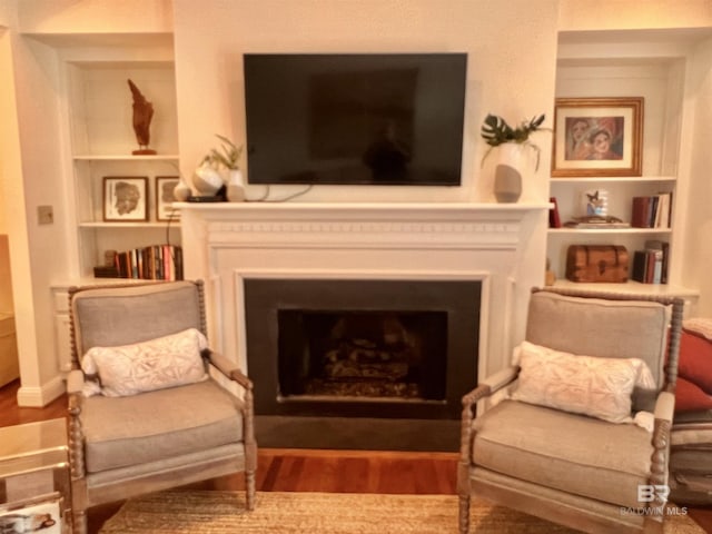18175 Scenic Highway 98 Unit 12, Fairhope, AL 36532 - sitting room with a fireplace, wood finished floors, and built in features
