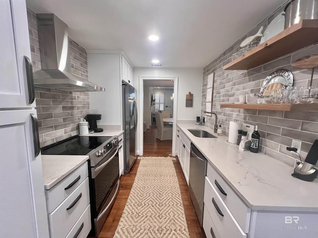 18175 Scenic Highway 98 Unit 12, Fairhope, AL 36532 - kitchen featuring stainless steel appliances, wall chimney exhaust hood, open shelves, backsplash, and recessed lighting
