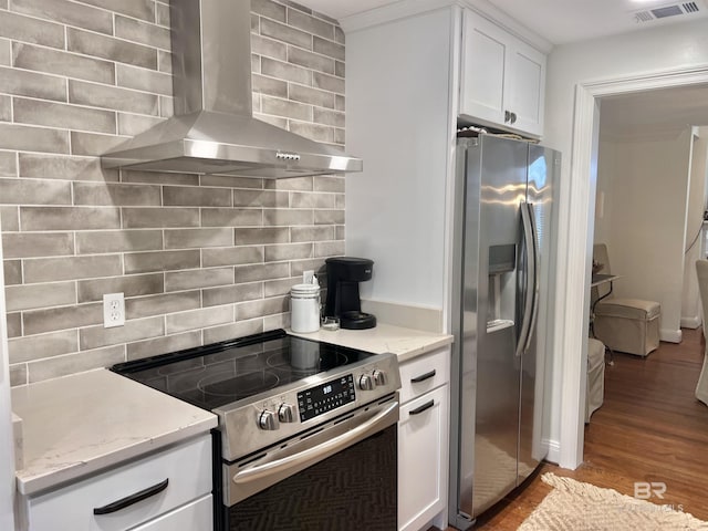 18175 Scenic Highway 98 Unit 12, Fairhope, AL 36532 - kitchen with stainless steel appliances, wall chimney range hood, light wood-style flooring, white cabinets, and backsplash