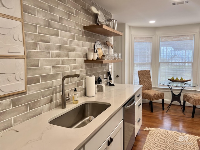 18175 Scenic Highway 98 Unit 12, Fairhope, AL 36532 - kitchen featuring stainless steel dishwasher, open shelves, tasteful backsplash, dark wood-style floors, and light stone counters