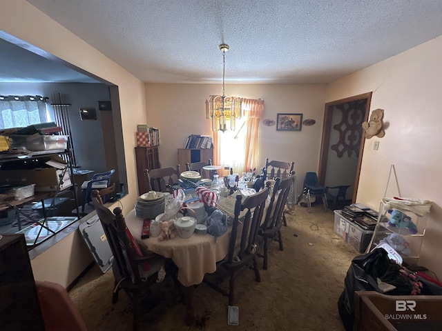 carpeted dining room featuring plenty of natural light, a chandelier, and a textured ceiling